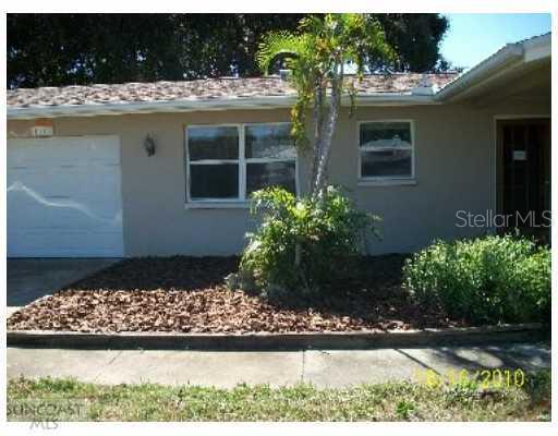 1143 Suemar Road Dunedin, FL 34698 - Photo 1 of 1 a front view of a house with a yard