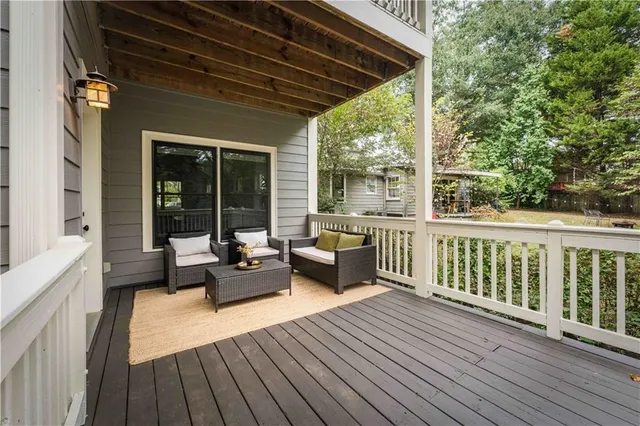 a outdoor living room with furniture and a large window