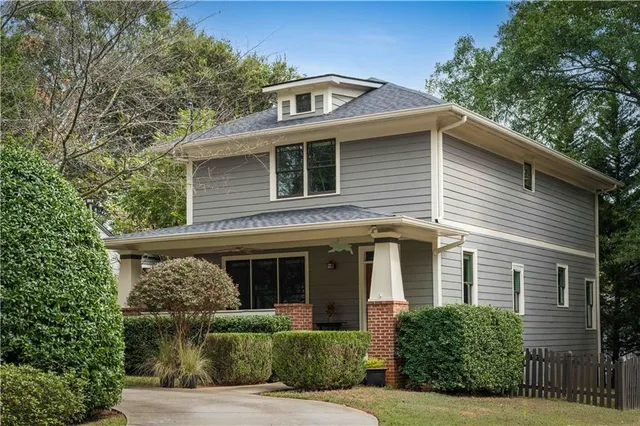 a front view of a house with plants