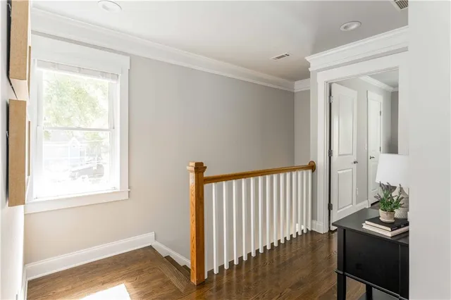 a bedroom with bed and wooden floor