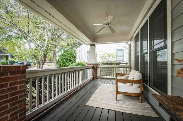 a balcony with chairs and wooden floor