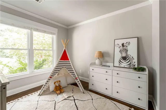 a bedroom with a bed and a chandelier fan