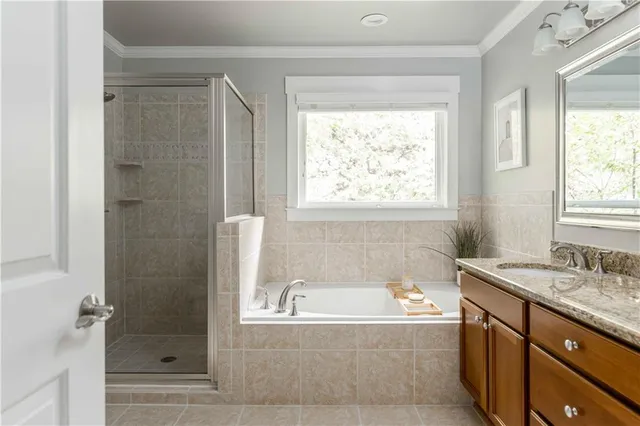 a bathroom with a granite countertop tub shower and sink
