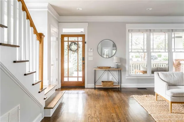 a living room with furniture a clock and a fireplace
