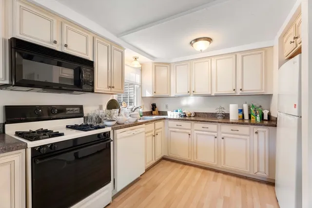 a kitchen with stainless steel appliances granite countertop a stove sink microwave and cabinets