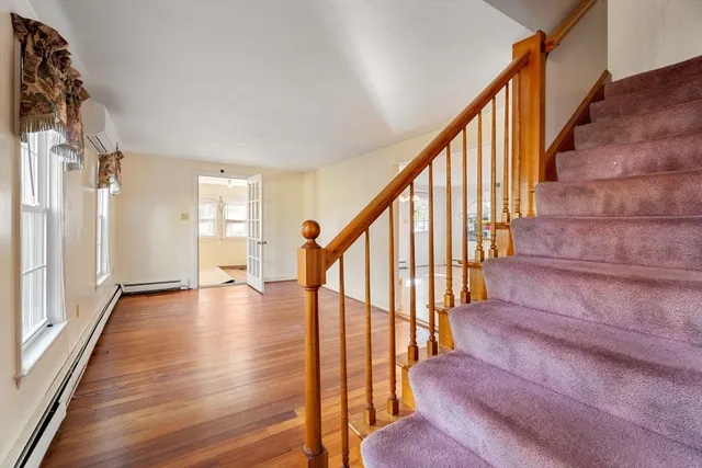 a view of staircase with wooden floor and stairs