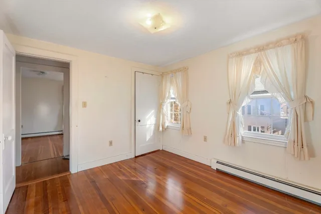 an empty room with windows and closet