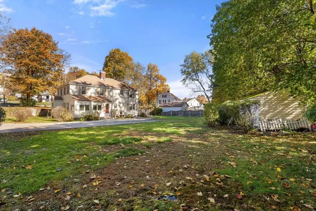 a view of yard with tree in the background