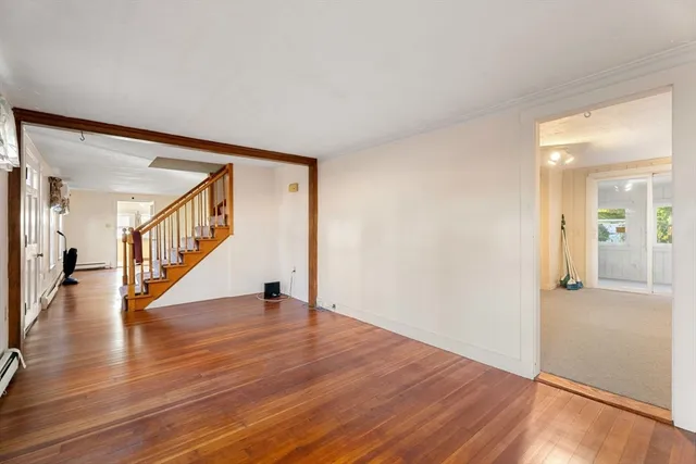 a view of an entryway with wooden floor