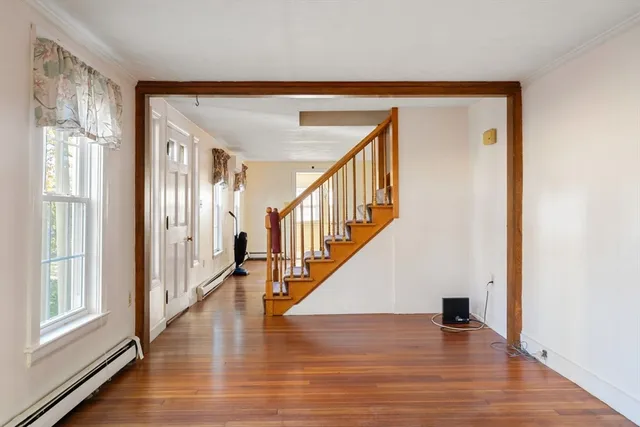 a view of an entryway with wooden floor
