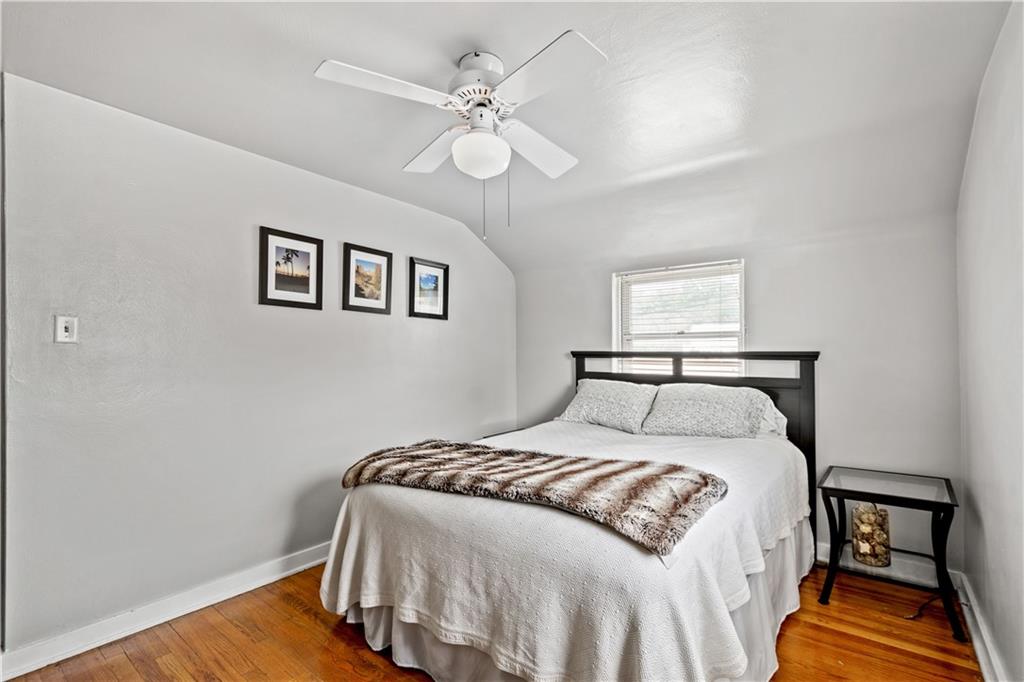 370 Vanadium Road Pittsburgh, PA 15243 - Photo 14 of 24 a bedroom with a bed and wooden floor