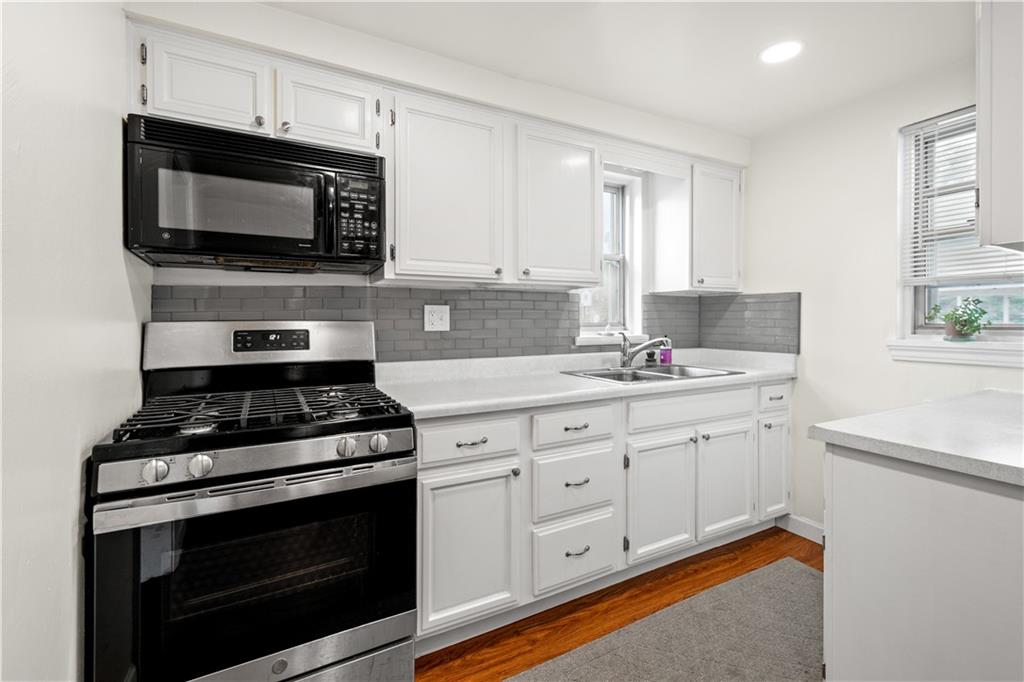 370 Vanadium Road Pittsburgh, PA 15243 - Photo 5 of 24 a kitchen with stainless steel appliances a stove microwave and sink