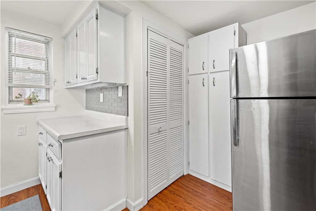 370 Vanadium Road Pittsburgh, PA 15243 - Photo 6 of 24 a white refrigerator freezer and a wooden cabinets