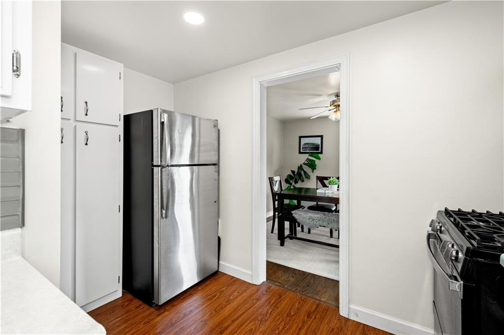 370 Vanadium Road Pittsburgh, PA 15243 - Photo 7 of 24 a kitchen with a refrigerator and a wooden floor
