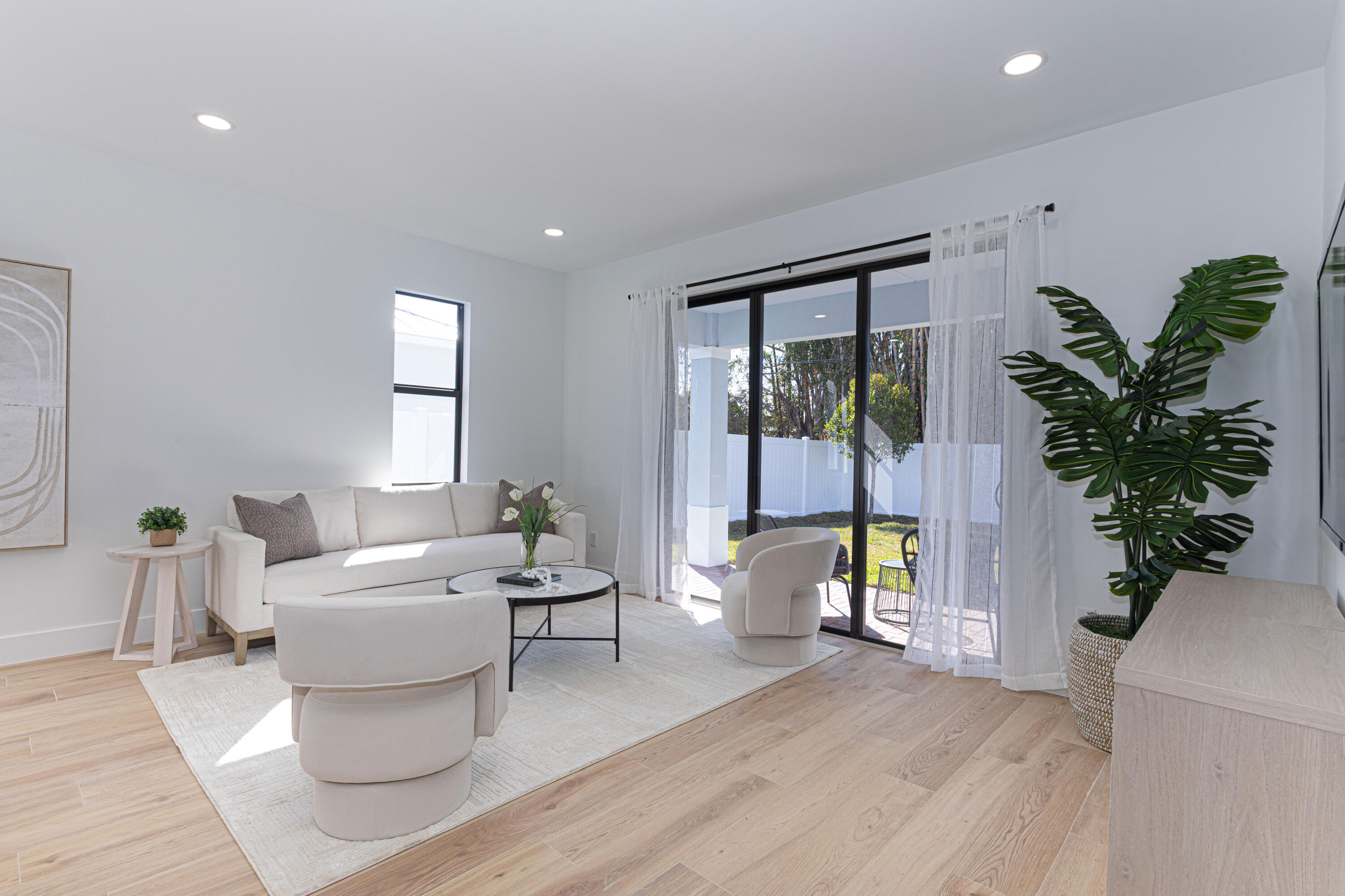 314 4th Street Jupiter, FL 33458 - Photo 13 of 55 a living room with furniture a potted plant and a large window