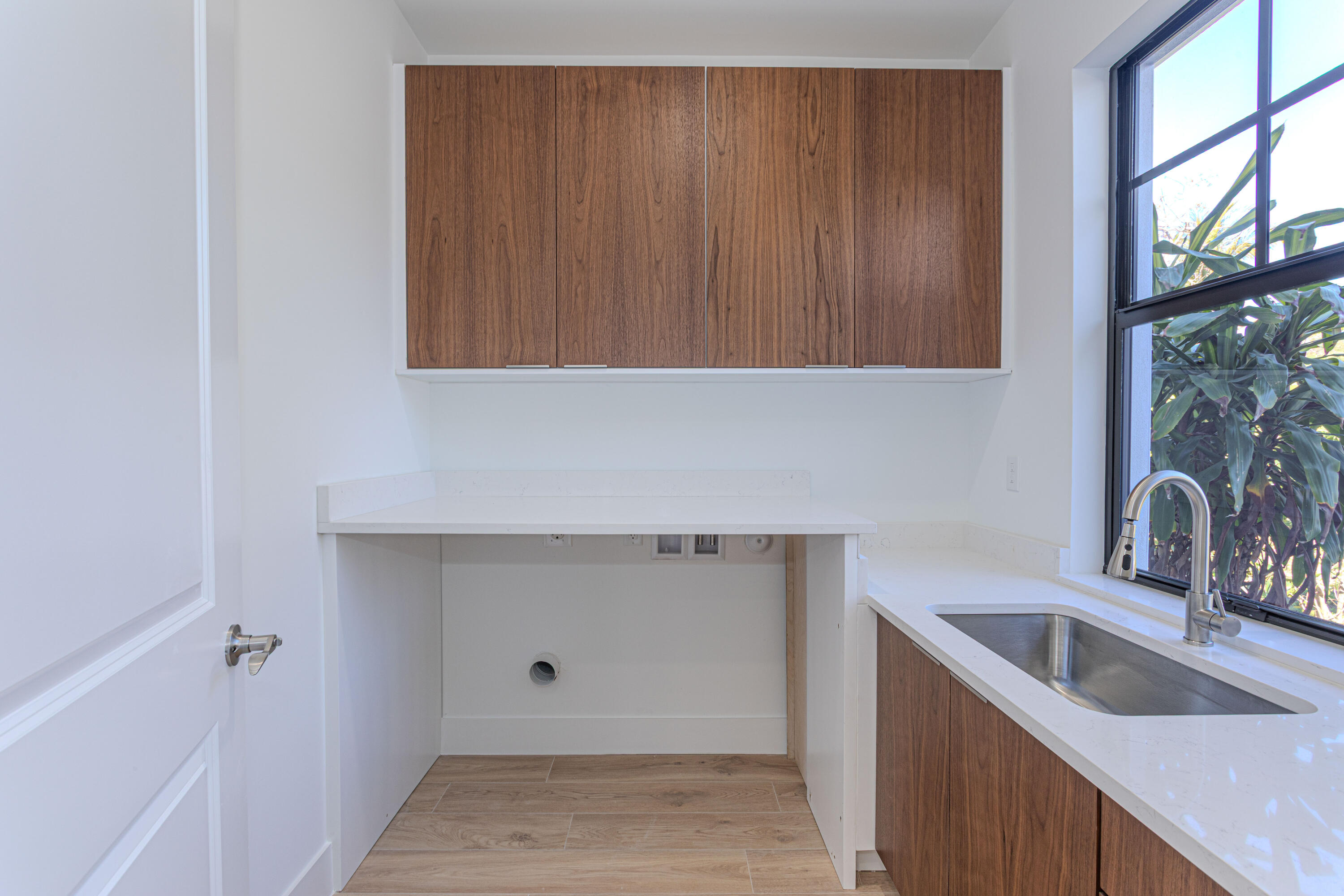314 4th Street Jupiter, FL 33458 - Photo 17 of 55 a kitchen with a sink cabinets and a wooden floor