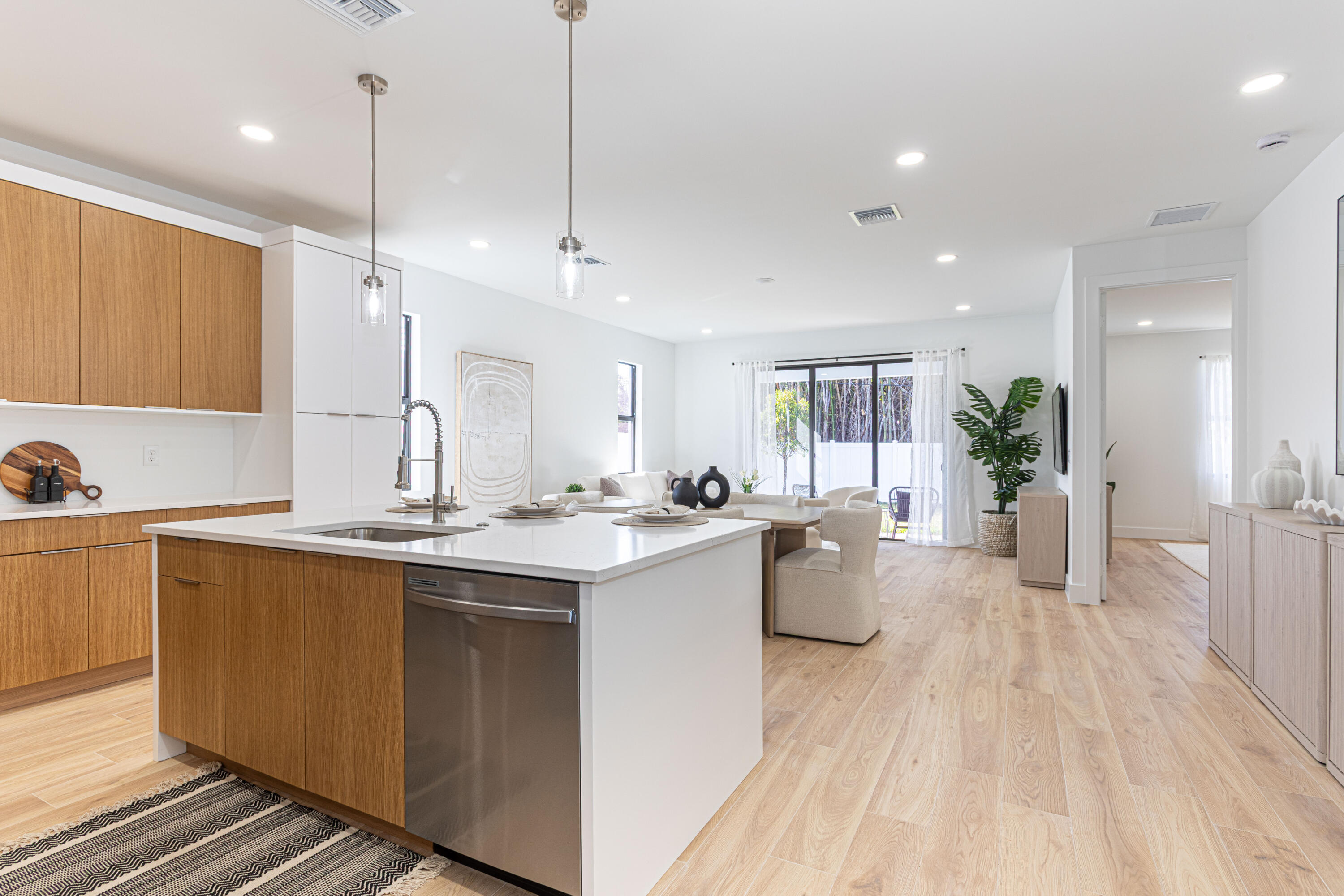 314 4th Street Jupiter, FL 33458 - Photo 18 of 55 a large kitchen with kitchen island white cabinets and wooden floor