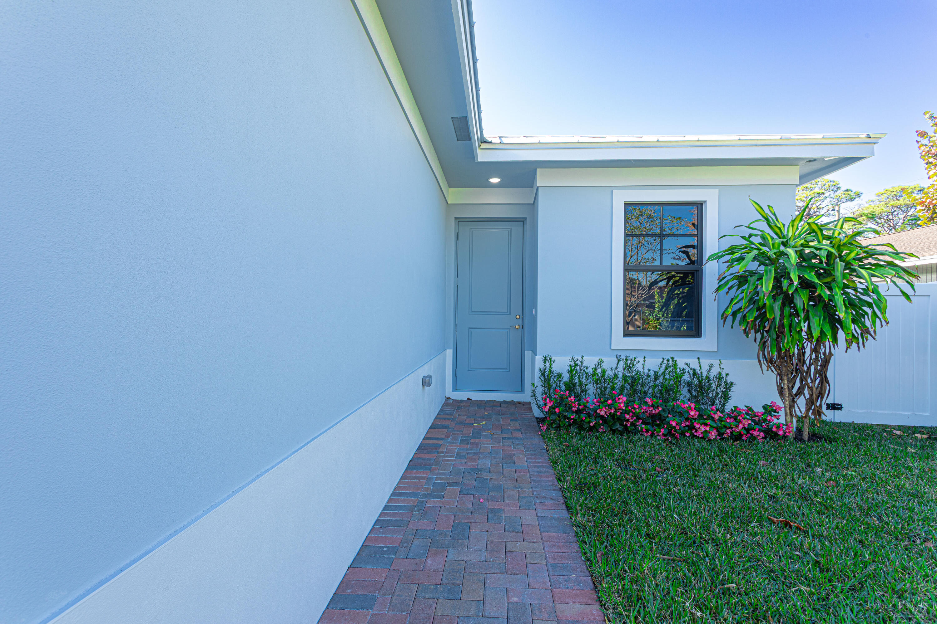 314 4th Street Jupiter, FL 33458 - Photo 2 of 55 a front view of a house with a garden