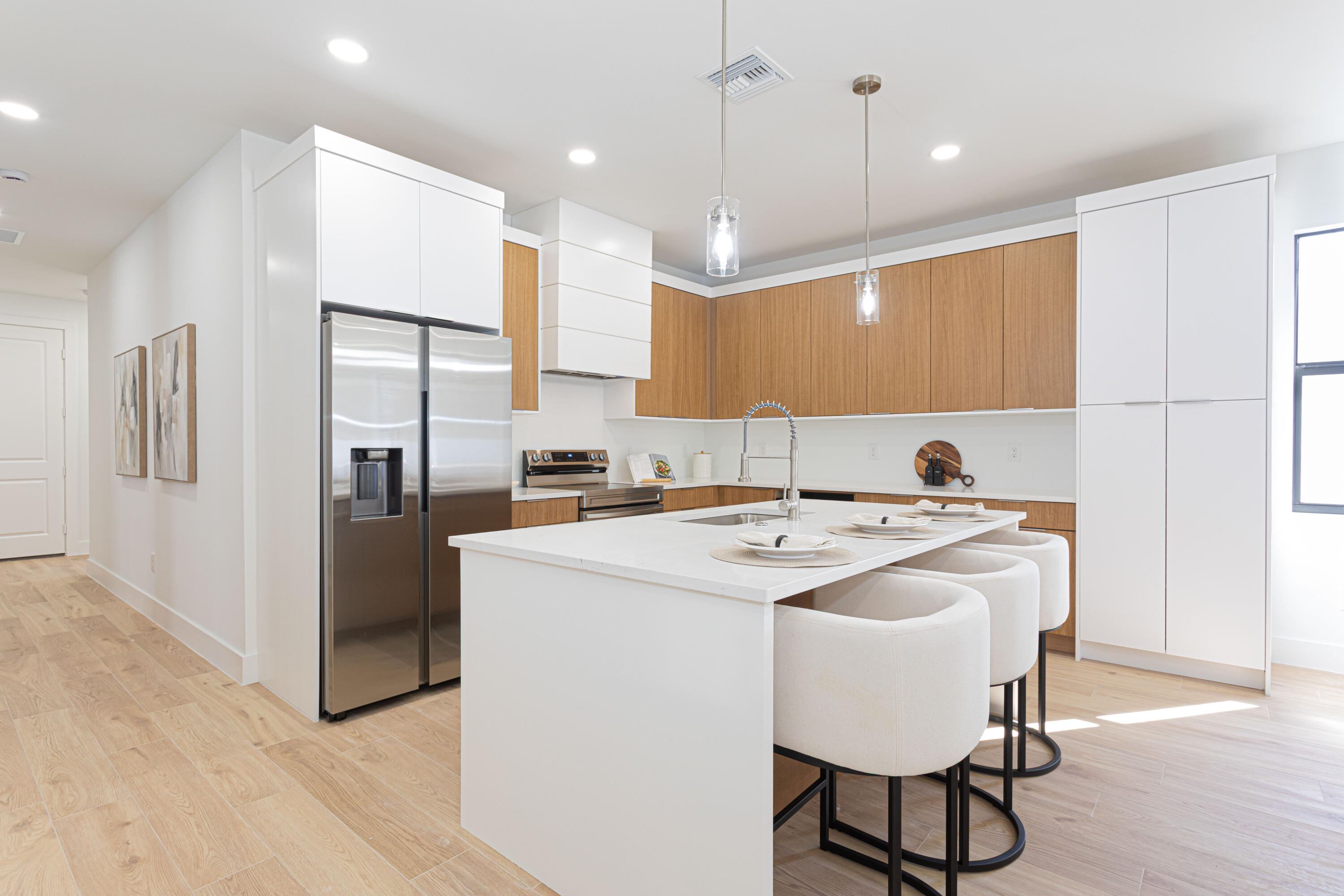 314 4th Street Jupiter, FL 33458 - Photo 23 of 55 a kitchen with stainless steel appliances granite countertop a sink a stove a refrigerator and island with wooden floor