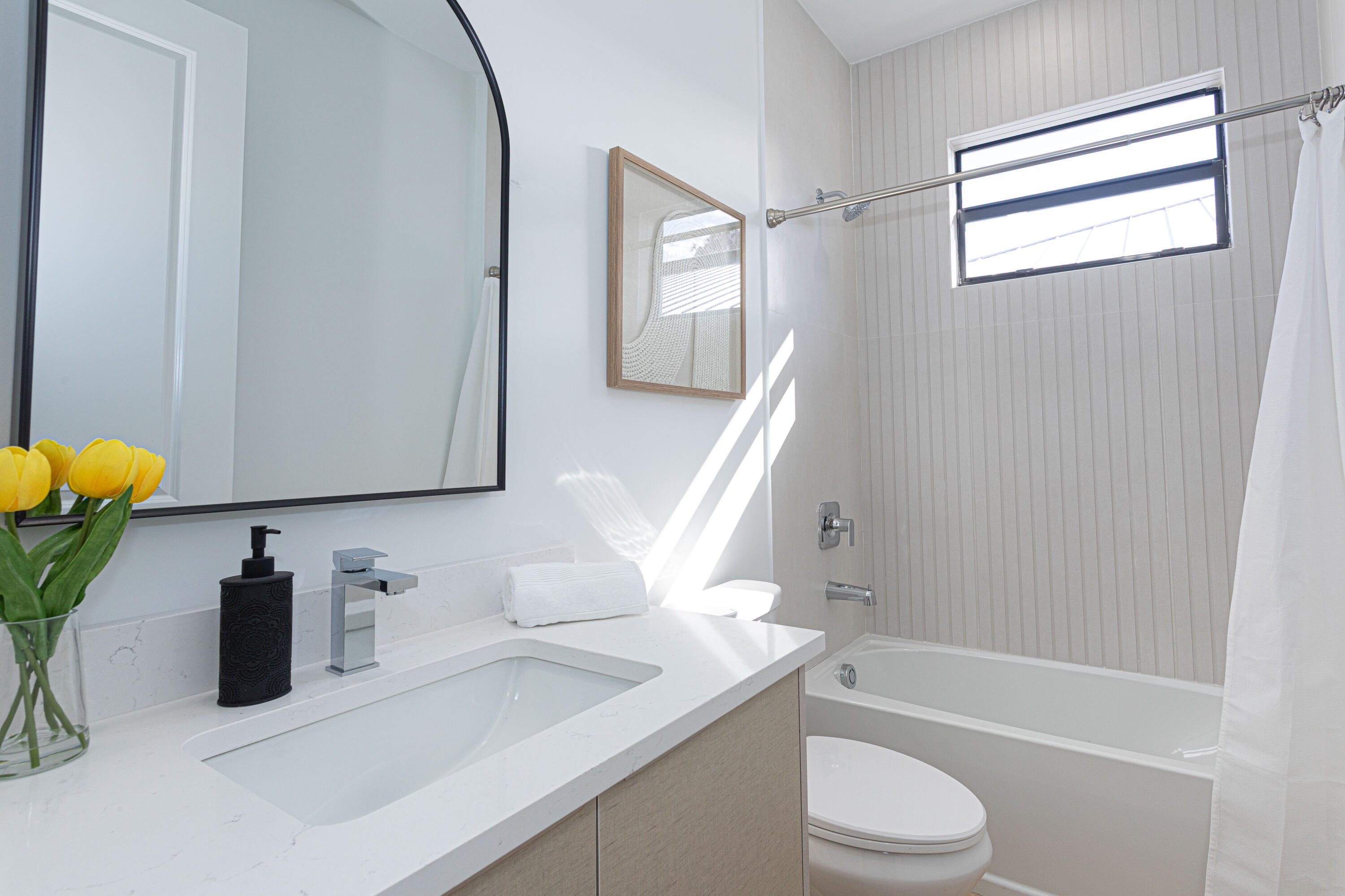314 4th Street Jupiter, FL 33458 - Photo 26 of 55 a bathroom with a granite countertop sink toilet a mirror and bathtub