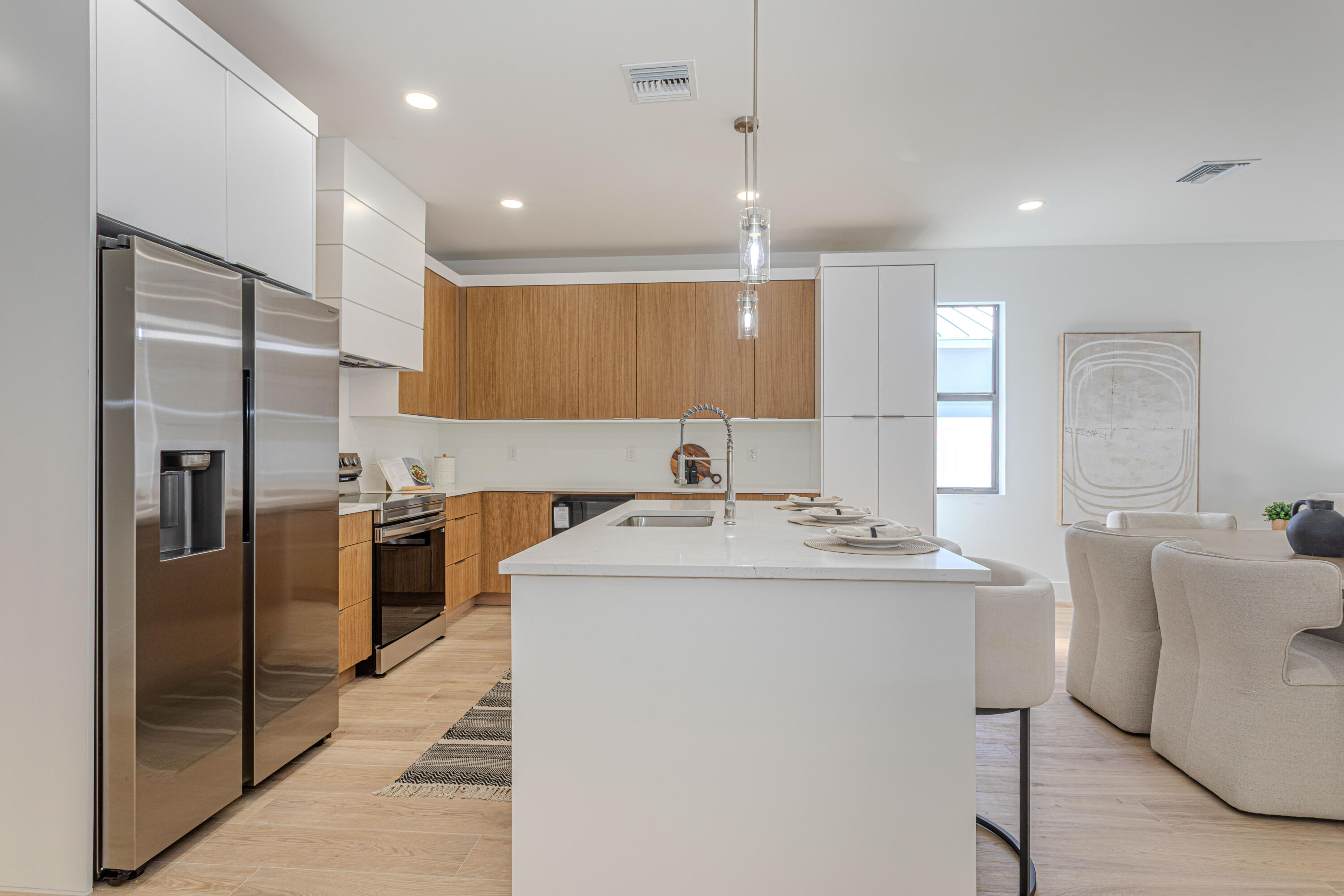 314 4th Street Jupiter, FL 33458 - Photo 28 of 55 a kitchen with stainless steel appliances granite countertop a sink a stove a refrigerator and island with wooden floor