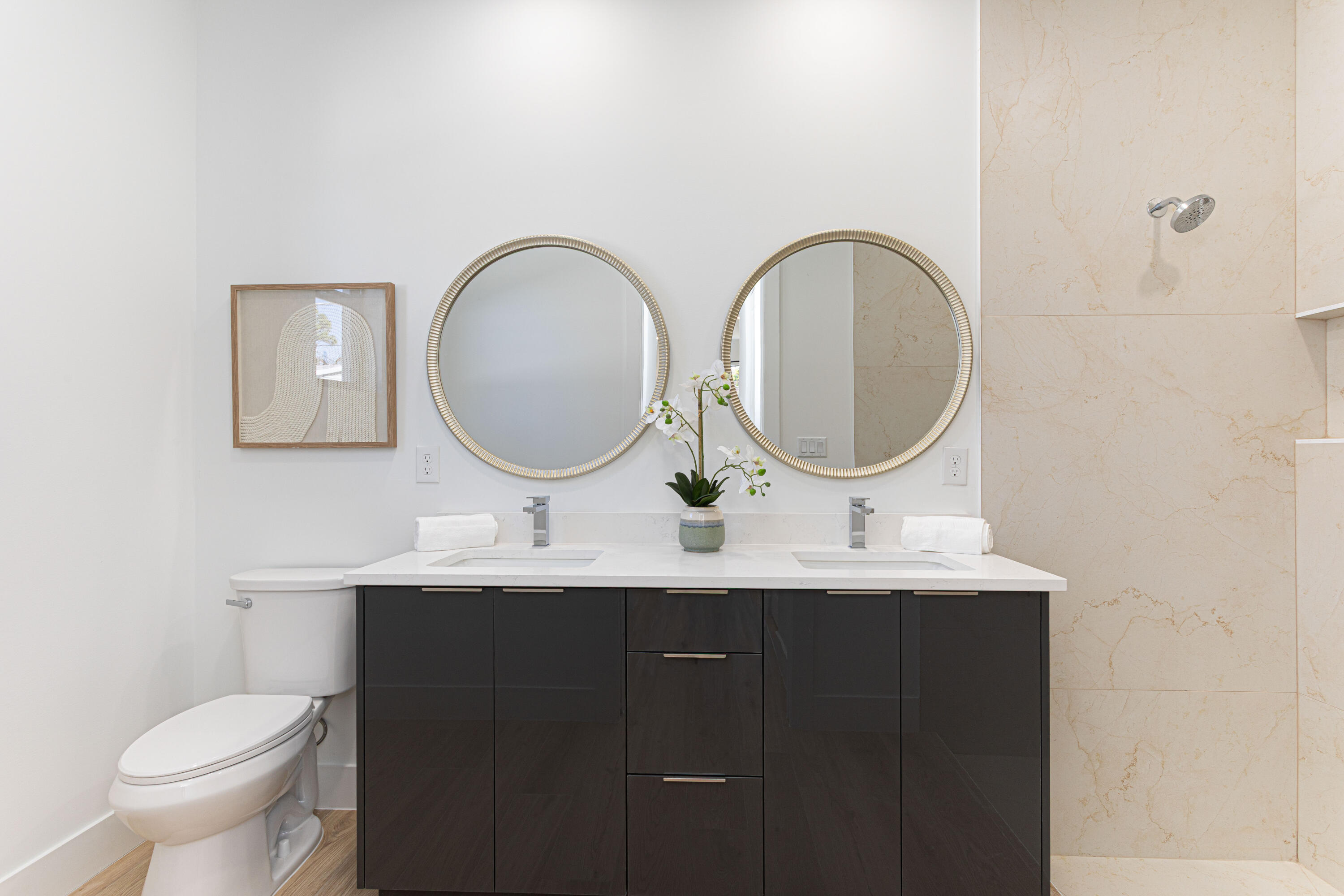 314 4th Street Jupiter, FL 33458 - Photo 32 of 55 a bathroom with a toilet a double vanity sink and a mirror