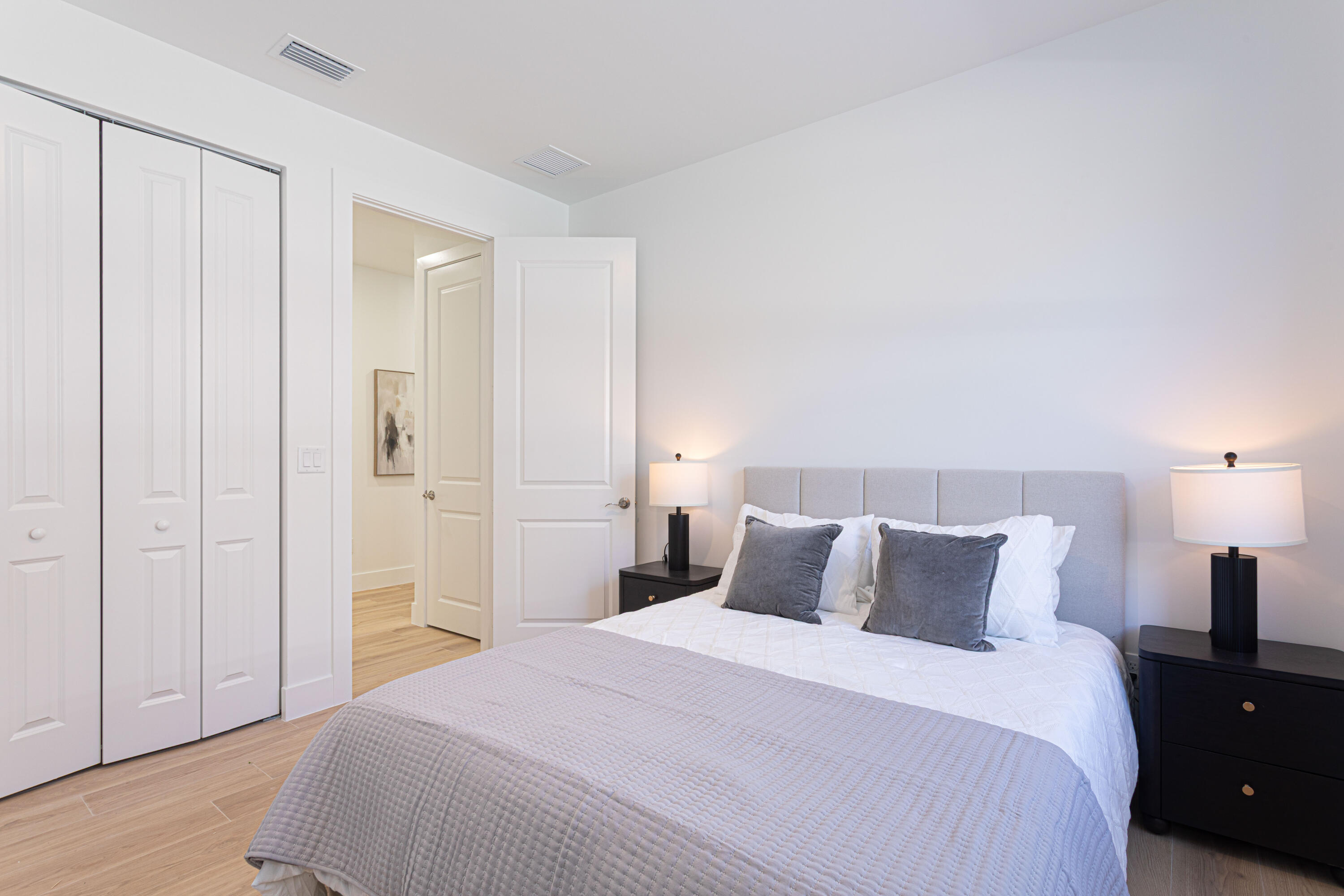314 4th Street Jupiter, FL 33458 - Photo 38 of 55 a bedroom with a bed and a lamp