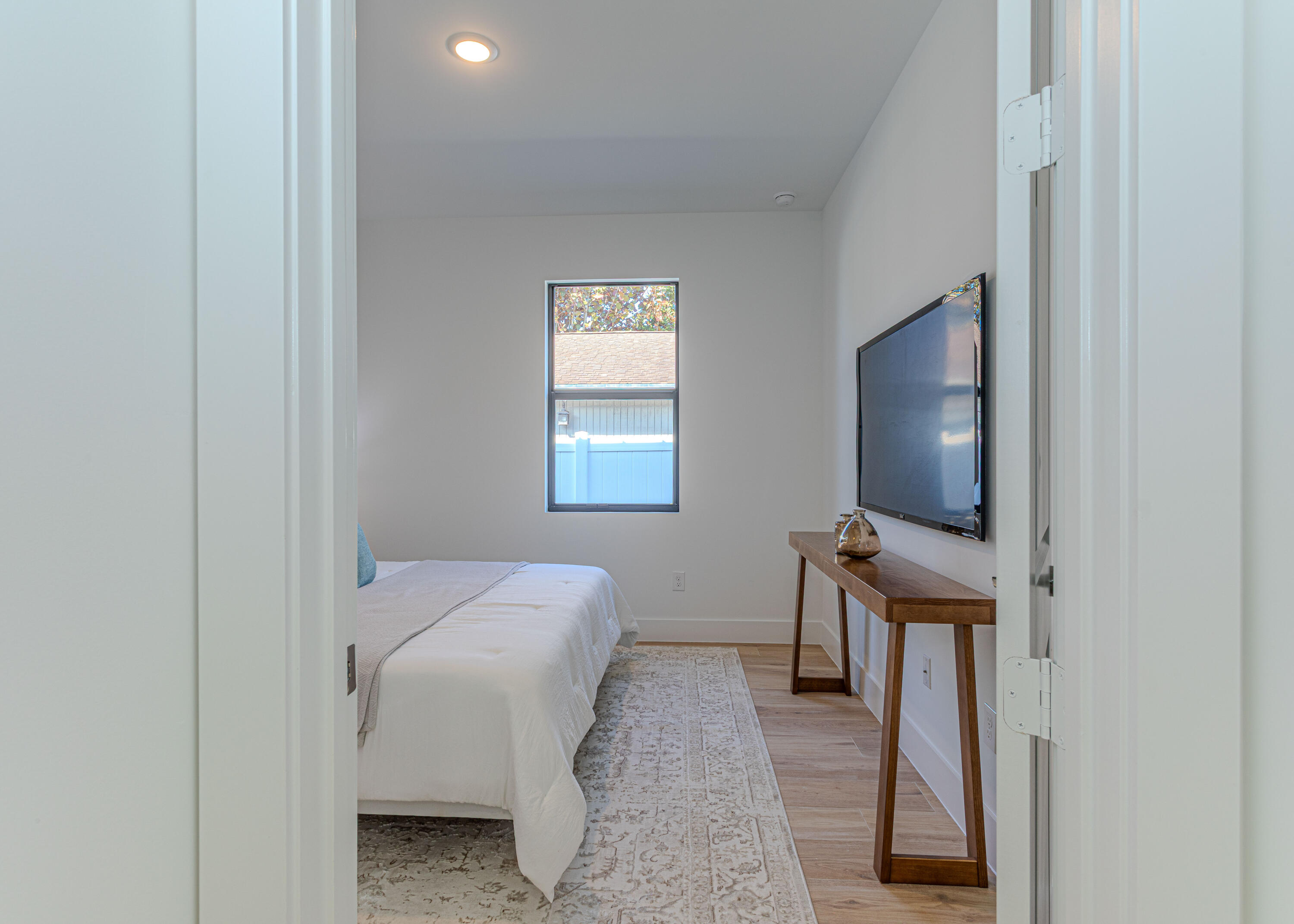 314 4th Street Jupiter, FL 33458 - Photo 39 of 55 a bedroom with furniture and a flat screen tv