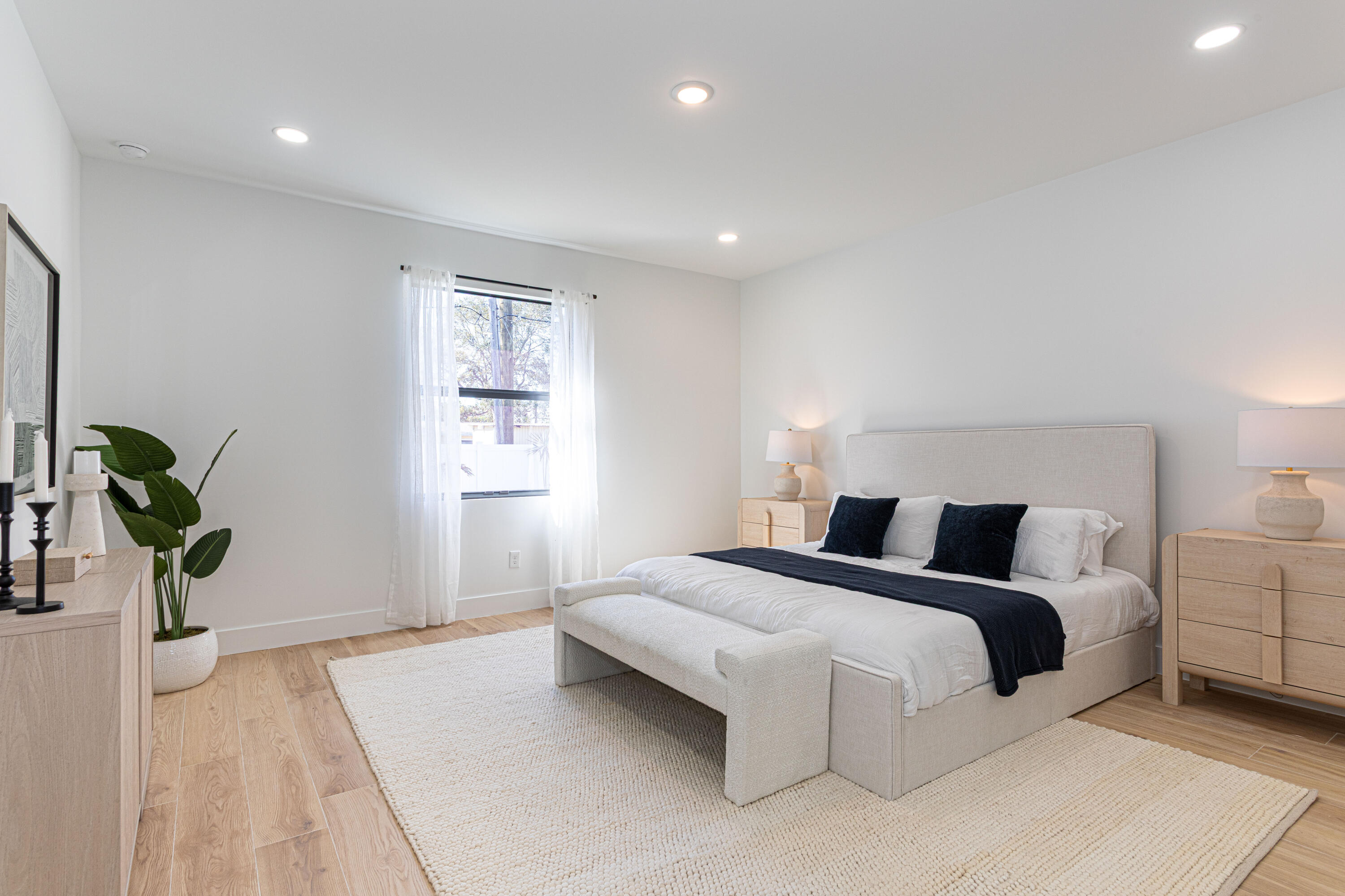 314 4th Street Jupiter, FL 33458 - Photo 40 of 55 a bedroom with a bed and a potted plant