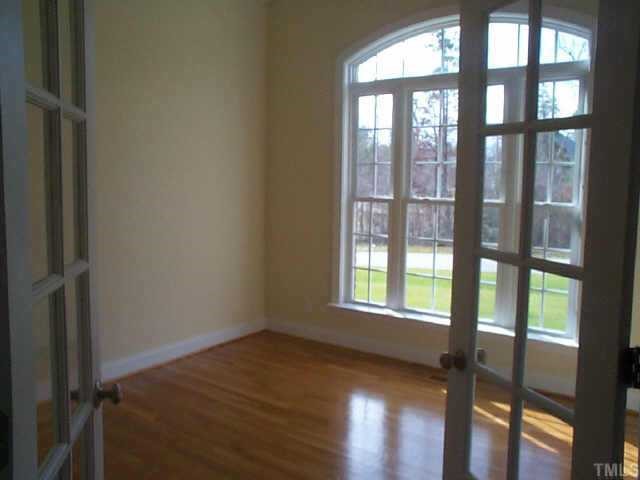 4200 Cypress Ridge Court Raleigh, NC 27616 - Photo 6 of 10 a view of an empty room and wooden floor and windows