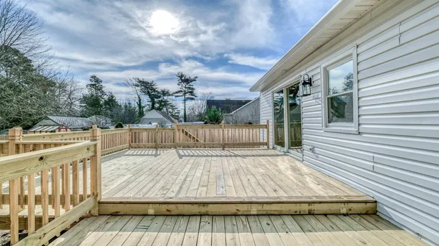 a view of a deck with a large trees