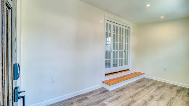 a view of a kitchen with wooden floor and a kitchen