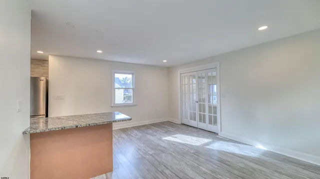 an empty room with wooden floor and a window
