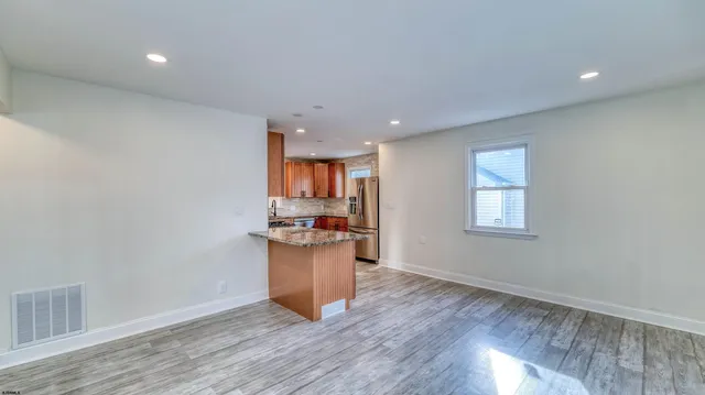 an empty room with closet and wooden floor