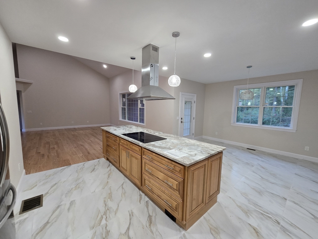 73 Dudley Hill Road Dudley, MA 01571 - Photo 13 of 33 a kitchen with a stove and a wooden floor