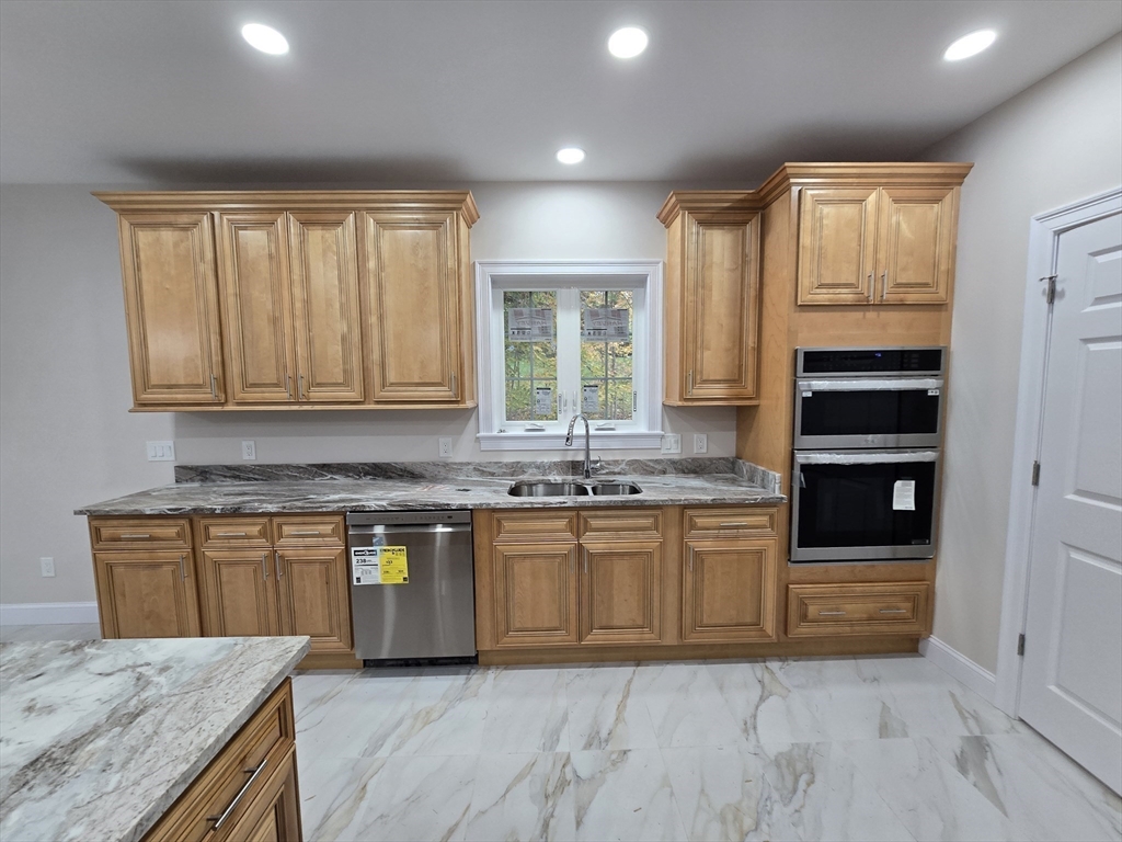 73 Dudley Hill Road Dudley, MA 01571 - Photo 14 of 33 a kitchen with stainless steel appliances granite countertop a stove a sink and a refrigerator