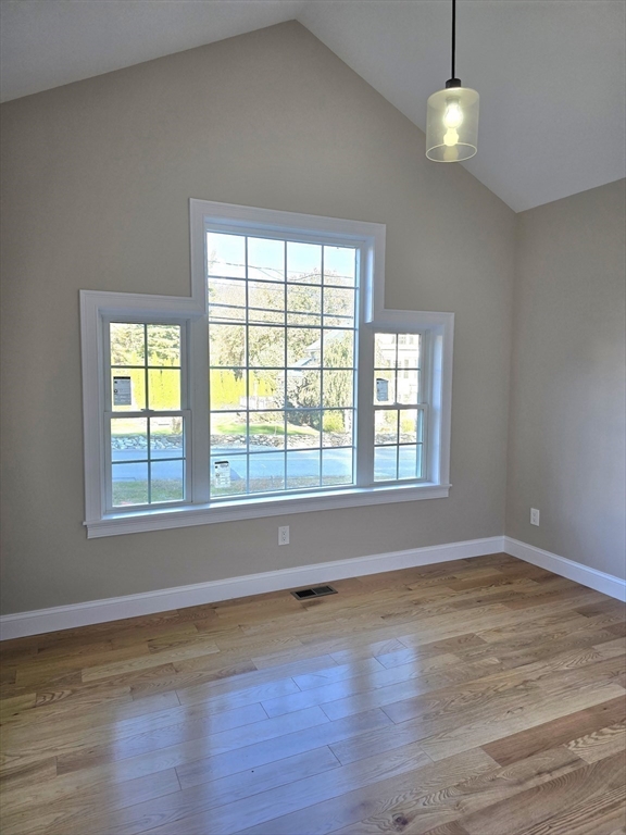 73 Dudley Hill Road Dudley, MA 01571 - Photo 19 of 33 a view of an empty room with wooden floor and a window