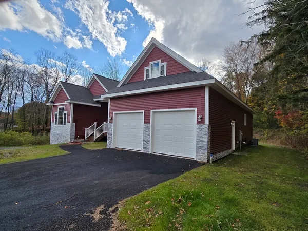 a front view of a house with a yard and garage