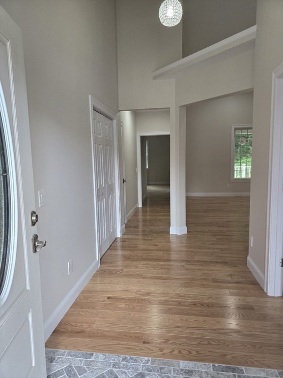 73 Dudley Hill Road Dudley, MA 01571 - Photo 10 of 33 a view of a hallway with wooden floor and staircase