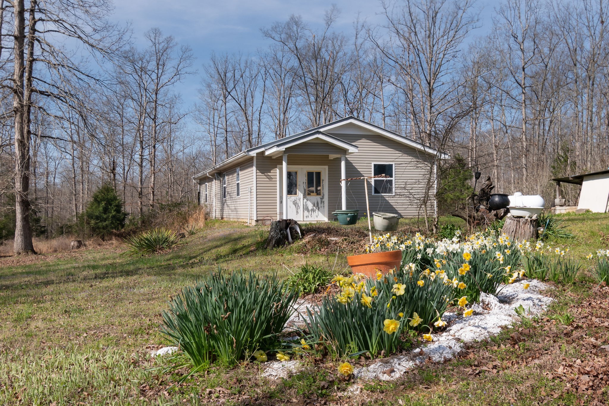 1300 New She Boss Road Duck River, TN 38454 - Photo 15 of 56 a front view of a house with a garden