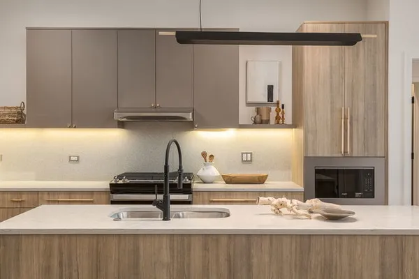 a kitchen with a stove and a refrigerator with wooden floor