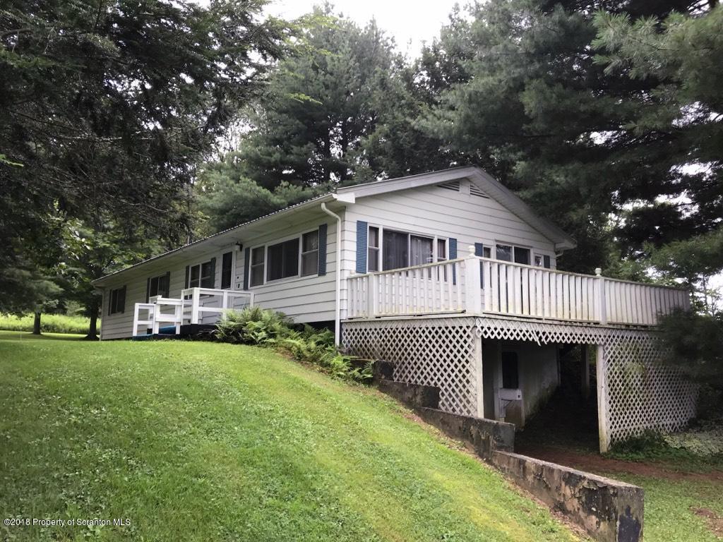 907 Pratt Hollow Road Nicholson, PA 18446 - Photo 1 of 33 a front view of a house with a garden