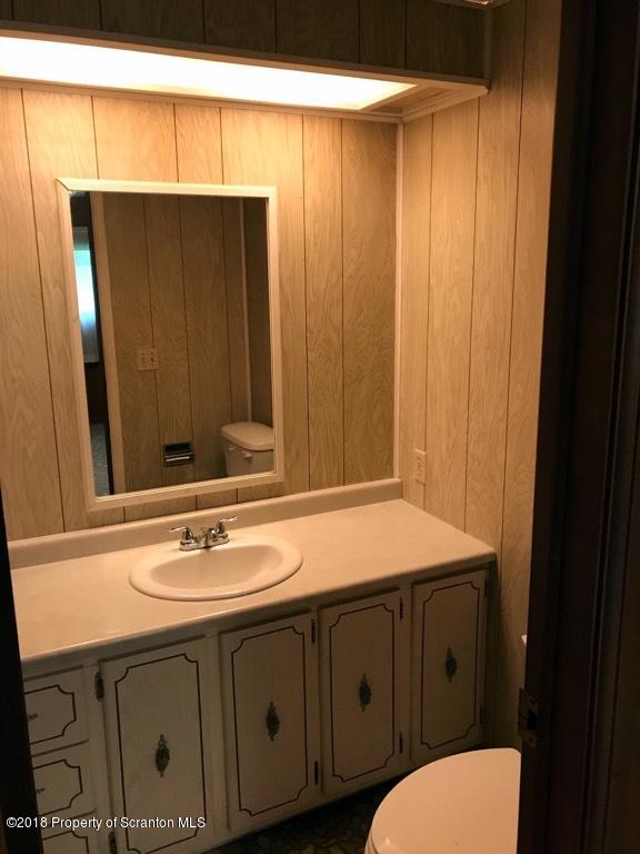907 Pratt Hollow Road Nicholson, PA 18446 - Photo 23 of 33 a bathroom with a sink a toilet and mirror