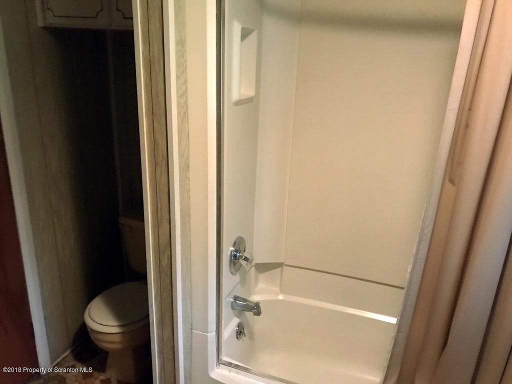907 Pratt Hollow Road Nicholson, PA 18446 - Photo 24 of 33 a bathroom with a bathtub and a toilet