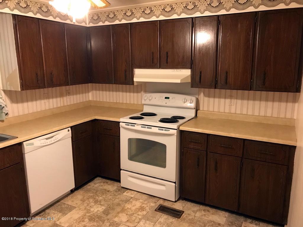 907 Pratt Hollow Road Nicholson, PA 18446 - Photo 26 of 33 a kitchen with a sink and a stove top oven