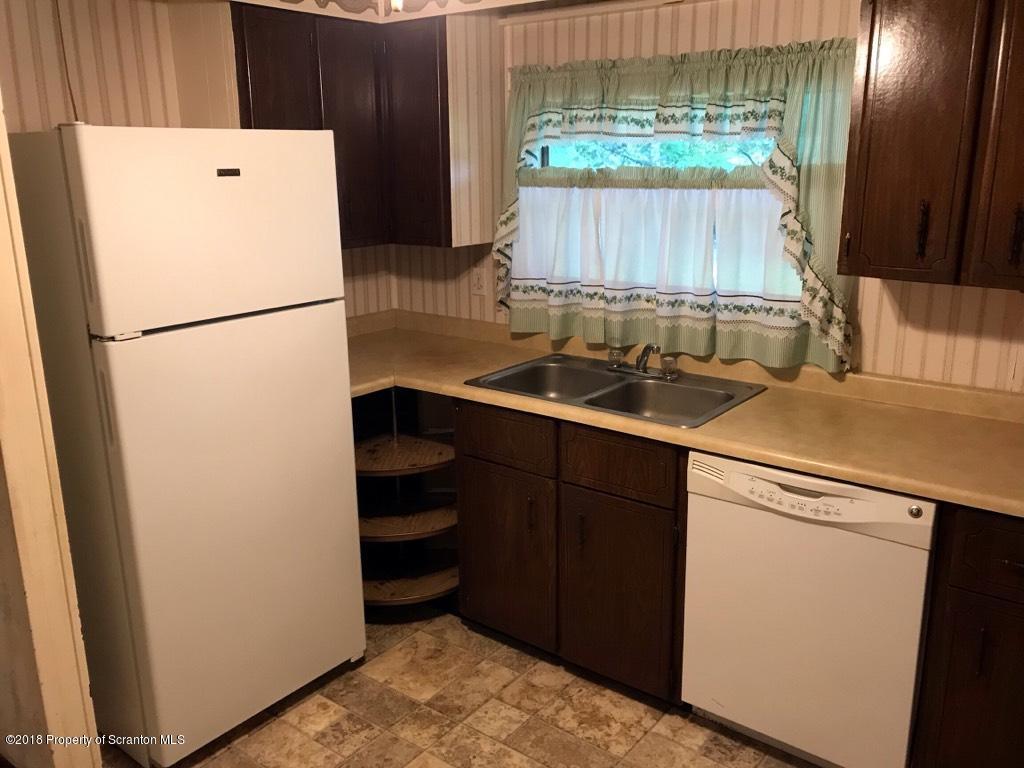 907 Pratt Hollow Road Nicholson, PA 18446 - Photo 27 of 33 a kitchen with a sink a refrigerator and a stove
