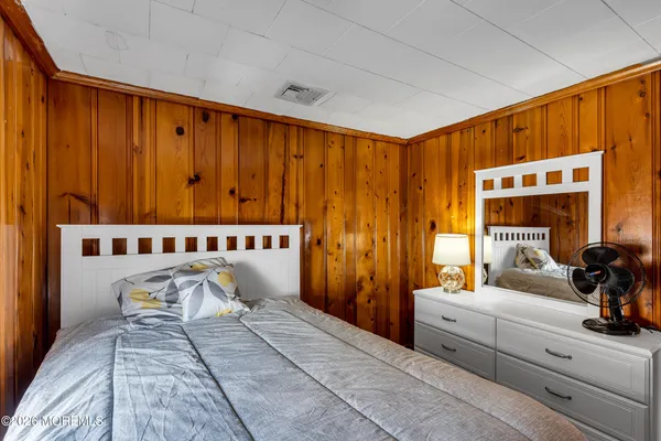a bedroom with a bed and a dresser