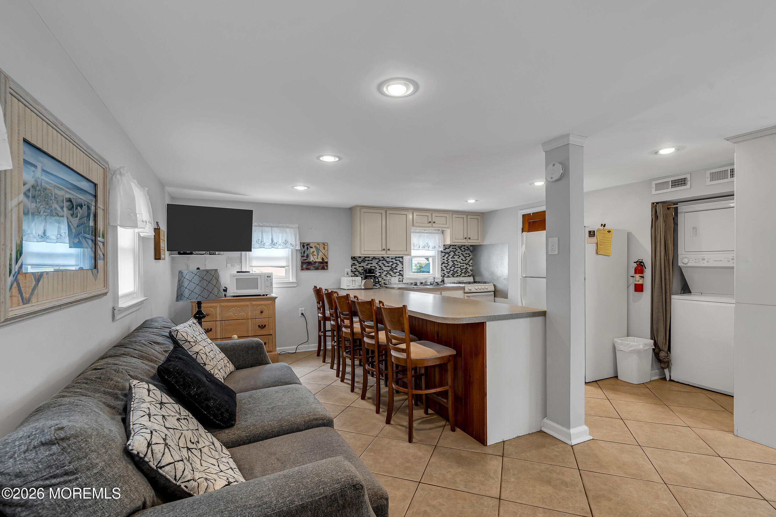 21 East Bay Way Lavallette, NJ 08735 - Photo 2 of 23 a living room with furniture a flat screen tv and kitchen view
