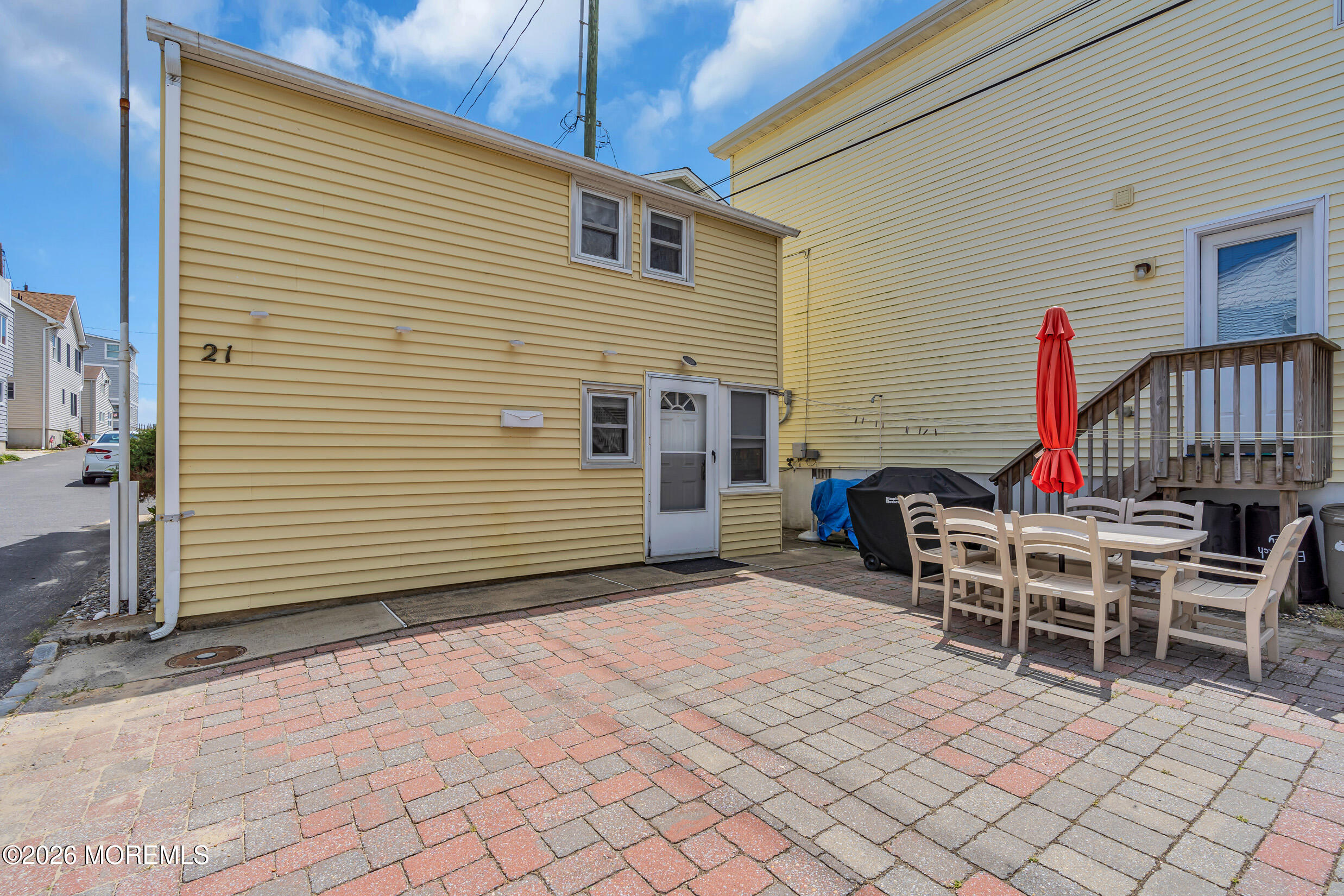 21 East Bay Way Lavallette, NJ 08735 - Photo 22 of 23 a view of a chairs and table in the back yard of the house