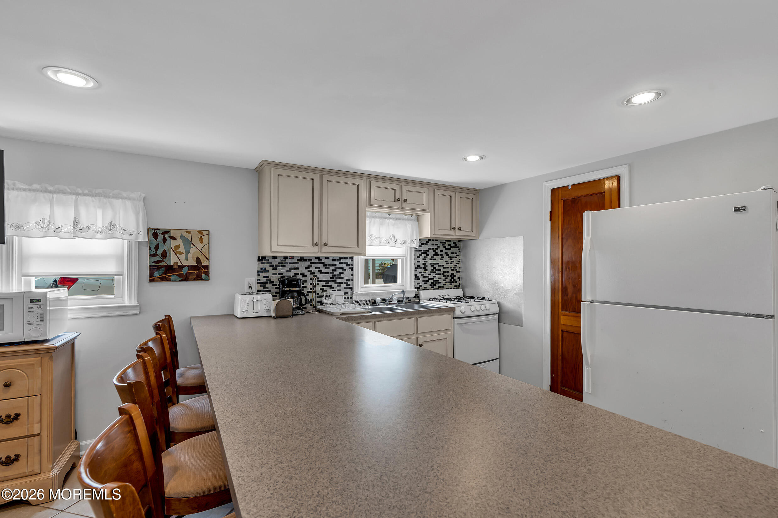 21 East Bay Way Lavallette, NJ 08735 - Photo 4 of 23 a kitchen with a refrigerator a stove and a sink